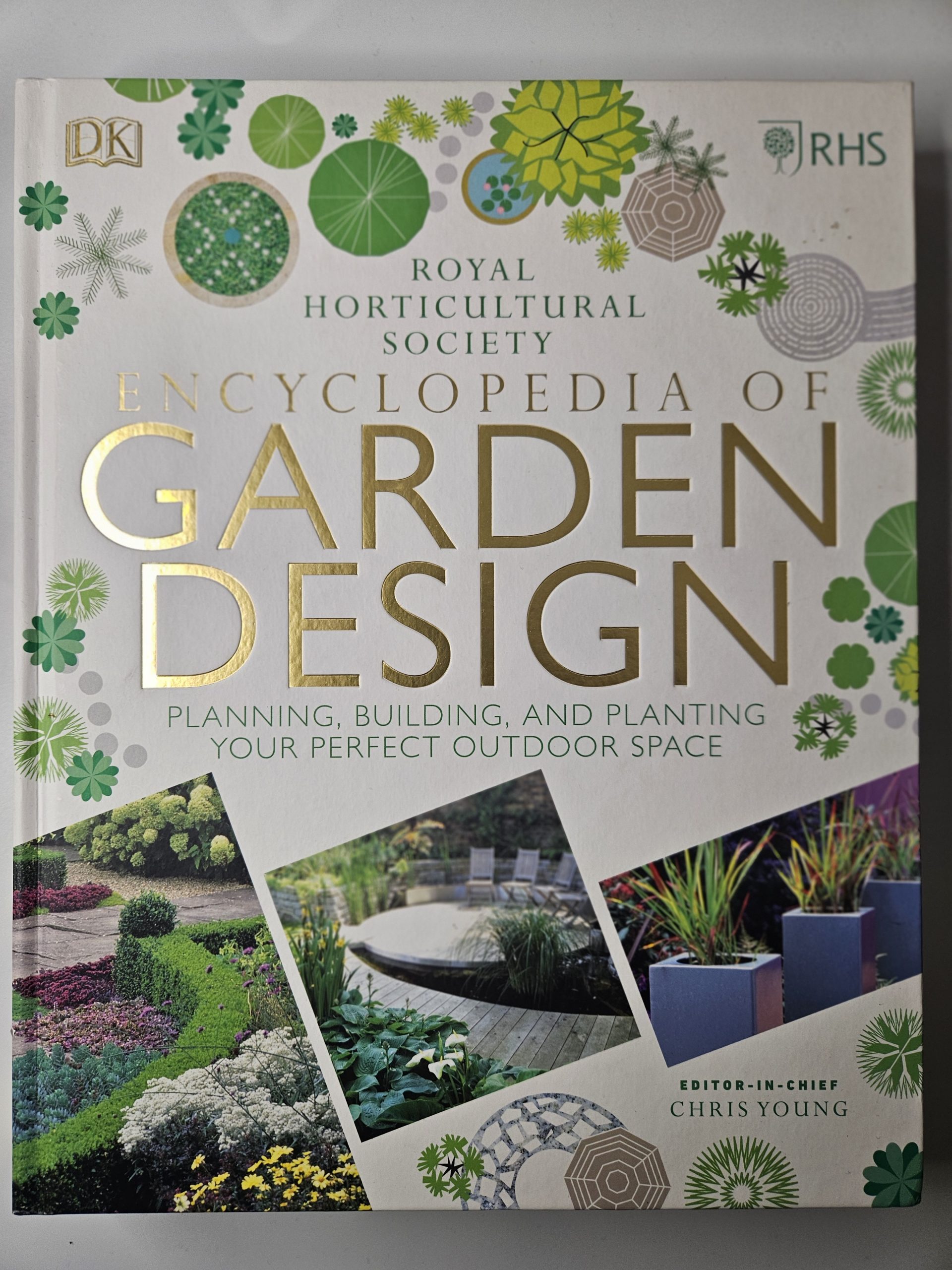 Cover of a garden design encyclopedia with gold title text and green botanical accents.